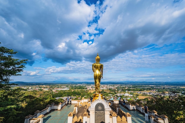 Nanthailand19122020Unacquainted People with beautiful cityscape and golden buddha statue on the mountain at Wat Phrathat Khao Noi at nan thailand