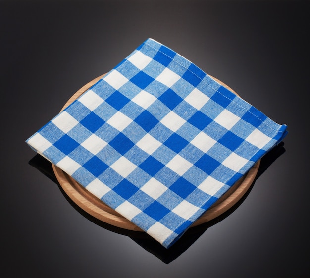 Napkin cloth and cutting board on black background