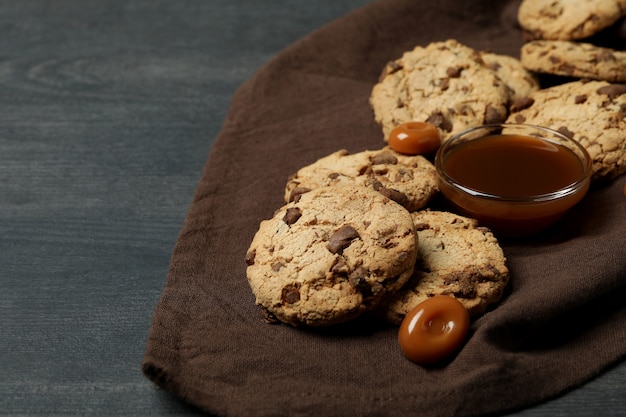 Napkin with cookies and caramel on dark wooden