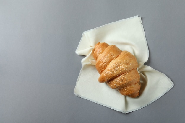 Napkin with croissant on gray