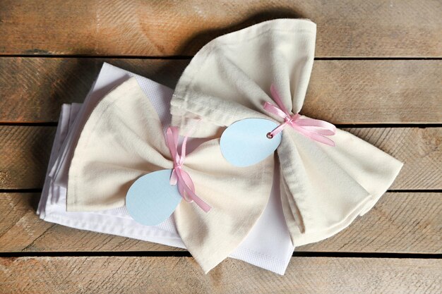 Napkin with Easter decorations on wooden background