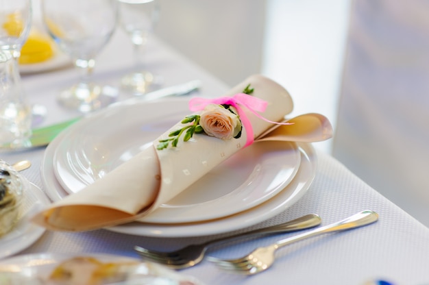 Napkin with rose flower on a plate