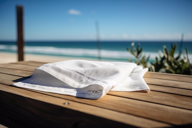 Napkin on a wooden table with a view of the beach and clear blue sky