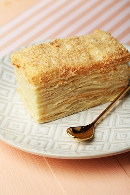 Napoleon cake on plate on table closeup