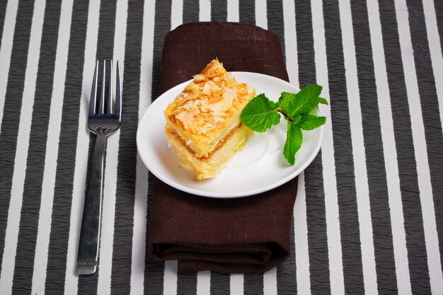 Napoleon cake on white plate