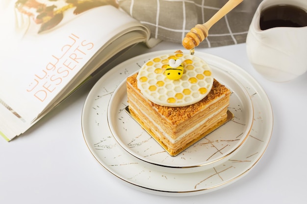 Photo napoleon cake with honey on a white background