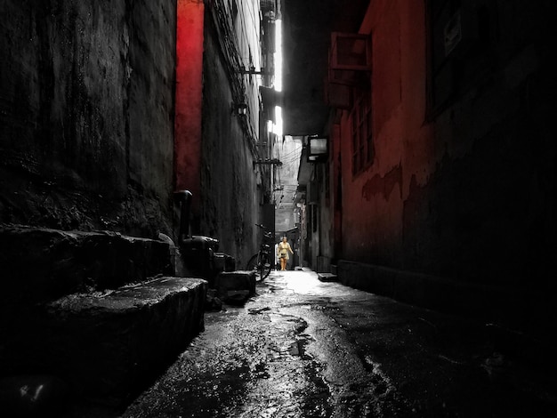 Photo narrow alley amidst buildings in city at night