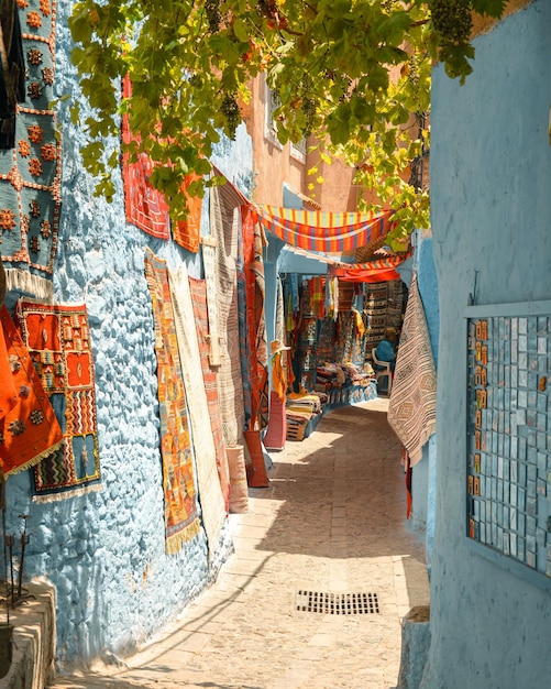 Narrow alley between beautiful bluewashed buildings in Chefchaouen Morocco