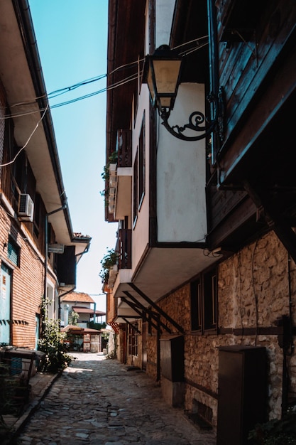 Narrow alley through small residential buildings in coastal Nesebar city in Bulgaria