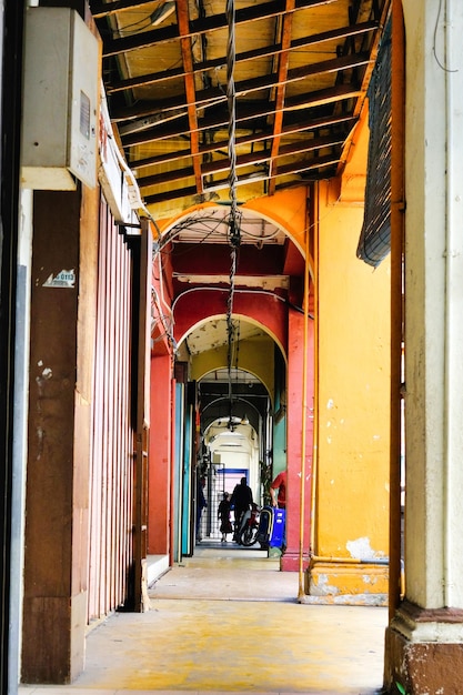 A narrow alley with a man on a bike