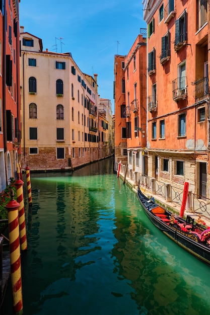 Narrow canal with gondola in Venice, Italy