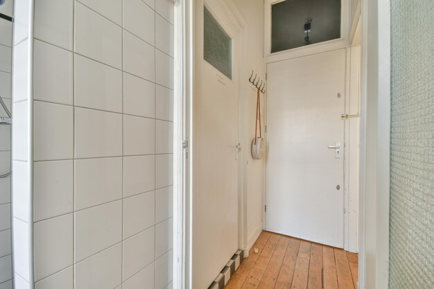 Narrow corridor with doors and lamp