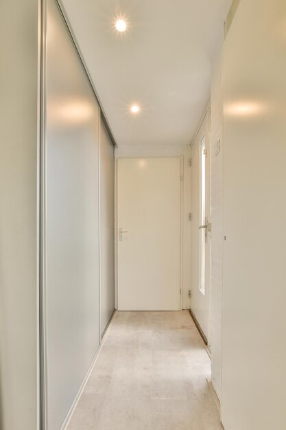 Narrow corridor with doors and lamp