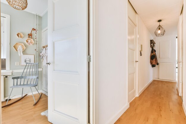 Narrow corridor with doors and lamp