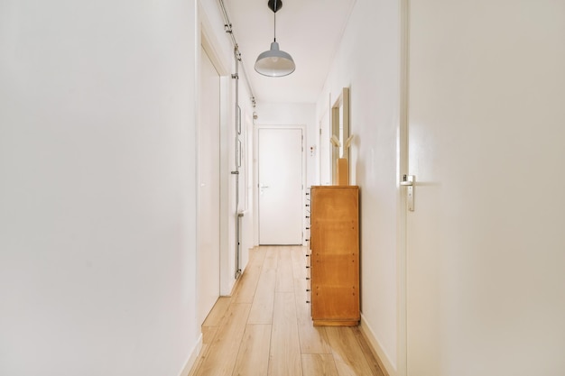 Narrow corridor with doors and lamp