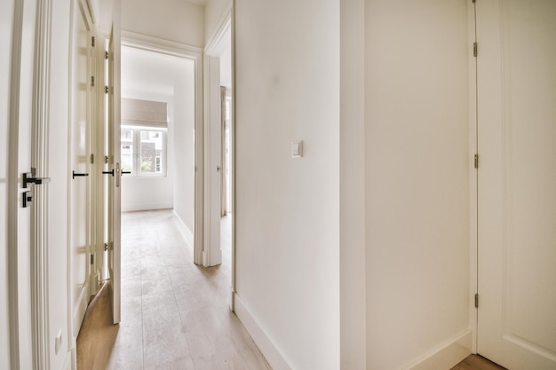 Narrow corridor with doors and lamp