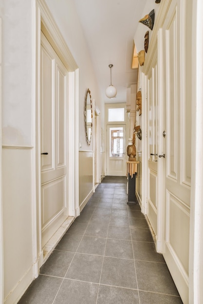 Narrow corridor with doors and lamp