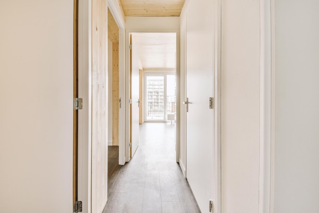 Narrow corridor with doors and lamp