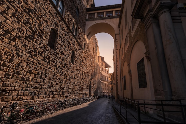 Narrow medieval street between ancient buildings made of rough stone blocks Florence Italy