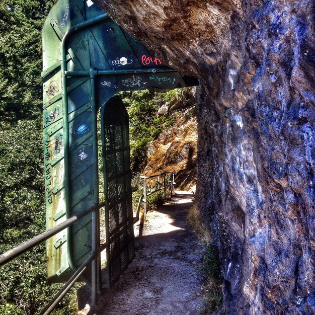 Foto stretto sentiero lungo pareti rocciose e ringhiere