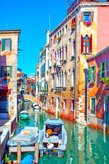 Narrow side canal in Venice on sunny day, Italy