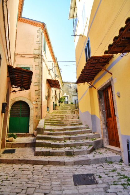 A narrow street between the old houses of Morcone a village in Campania Italy