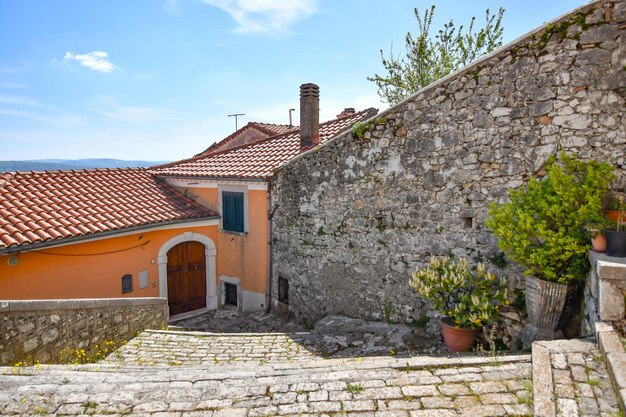 A narrow street between the old houses of Morcone a village in Campania Italy