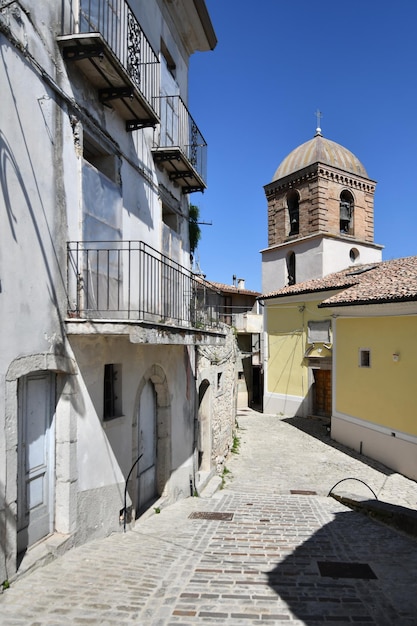 A narrow street between the old houses of Morcone a village in Campania Italy