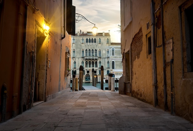 Narrow street in Venice leading to a pier, Italy