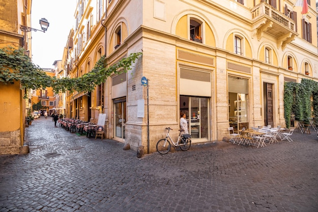 Narrow street with cafe and small shops in rome