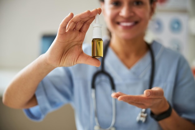 Nasal spray being introduced by a happy medic