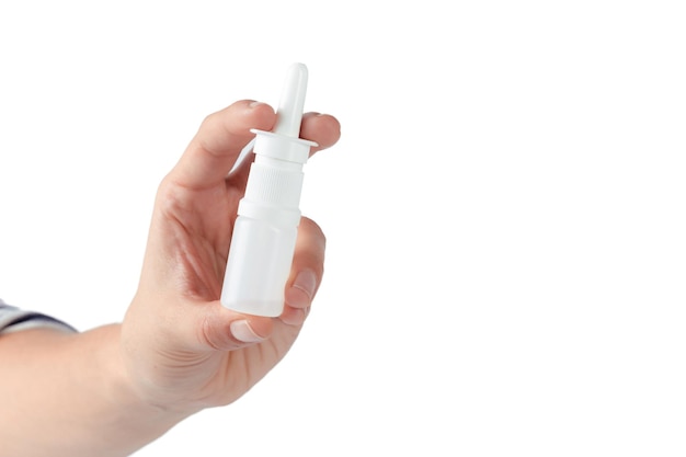 Nasal spray in a human hand isolated on white background