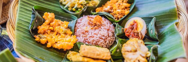 Nasi lemak nasi campur indonesian balinese rice with potato fritter sate lilit fried tofu spicy