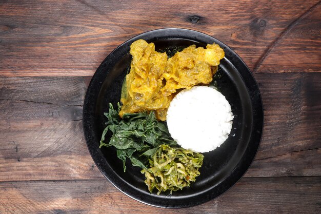 Nasi Padang with Gulai Kikil and various side dish or condiment.