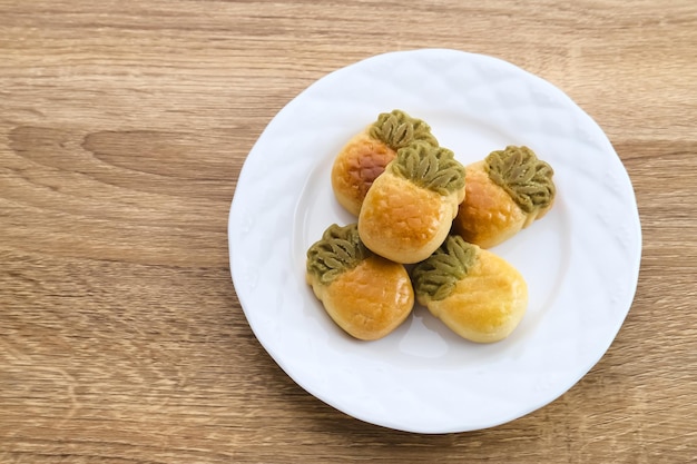 Nastar Cookies Taiwanese Pineapple Cookies with pineappleshaped filled with jam Served in plate