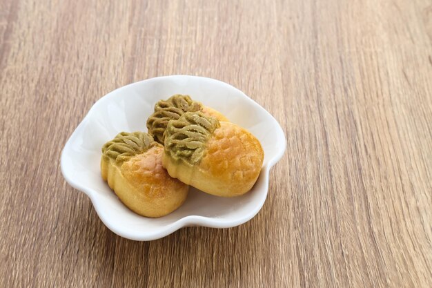 Nastar Cookies Taiwanese Pineapple Cookies with pineappleshaped filled with jam Served in plate