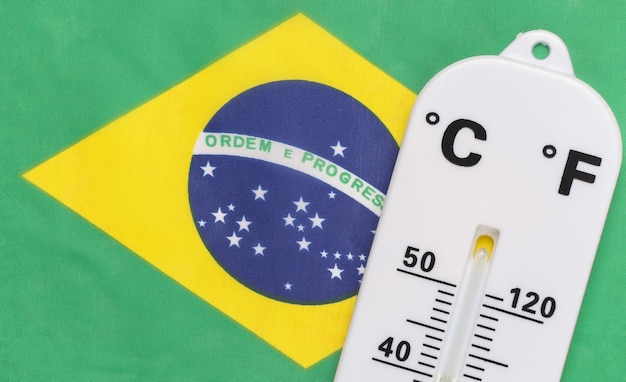 National Ambient Temperature Control. Weather thermometer on the background of Brazil flag. Global warming concept