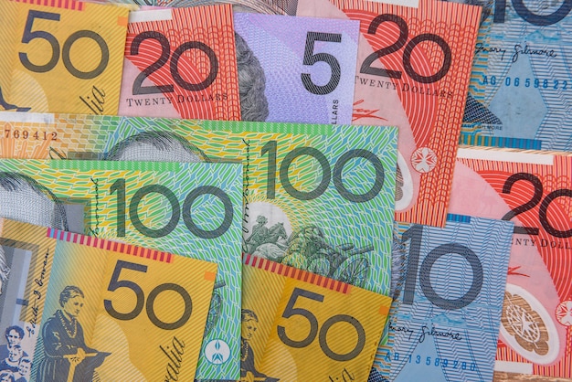 National currency. Colorful australian dollar banknotes on wooden table close up