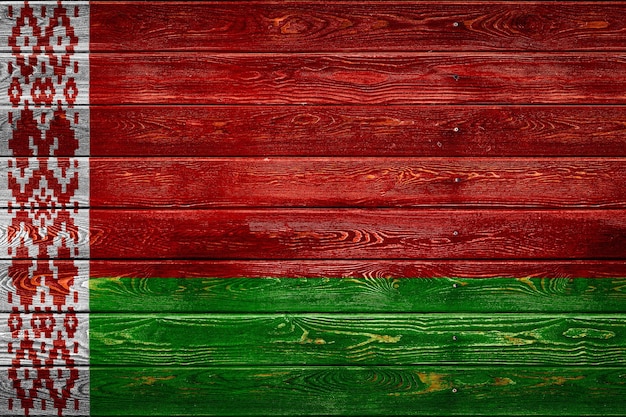 Photo the national flag of belarus is painted on a camp of even boards nailed with a nail. the symbol of the country.