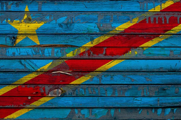 The national flag of Democratic Republic of the Congo is painted on uneven boards Country symbol