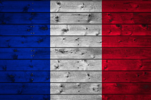 national flag of France is painted on a camp of even boards nailed with a nail.