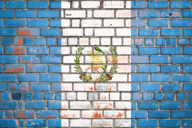 National flag of the Guatemala on a grunge brick background