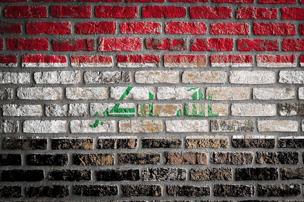 Photo national flag of irak on an old brick wall