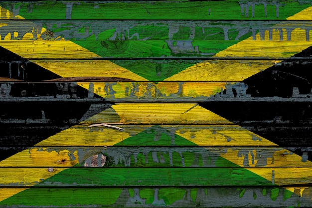 Photo the national flag of jamaica is painted on uneven boards country symbol