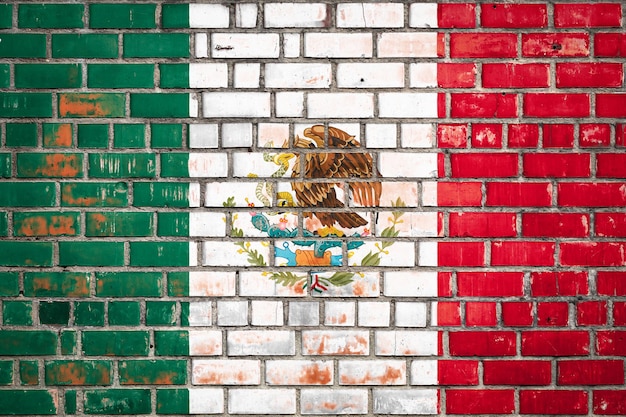 National flag of the Mexico on a grunge brick background