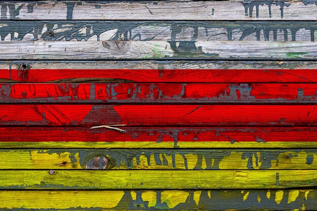 The national flag of Ossetia is painted on uneven boards Country symbol