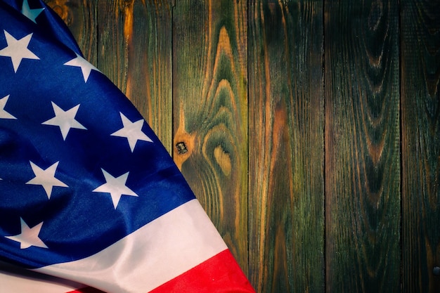 The national flag of the United States on a wooden background with a place to copy.