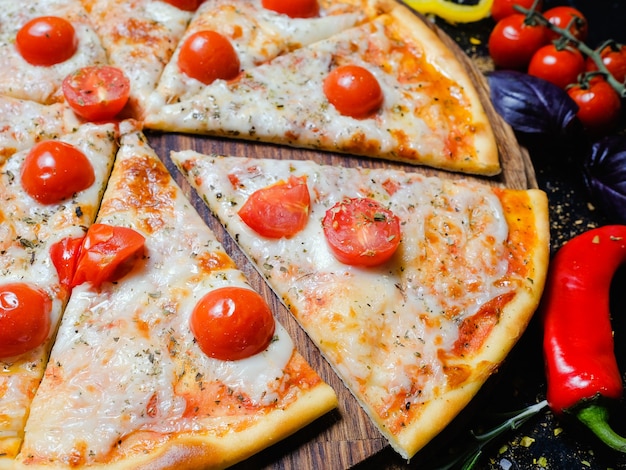 National italian food meal. delicious pizza slice with melted cheese and cherry tomatoes