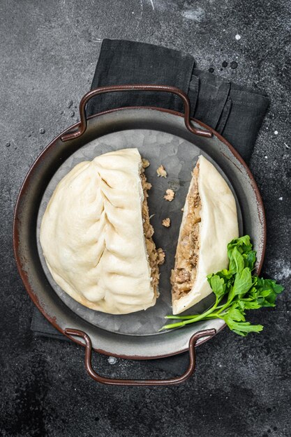 National Korean fast food steamed pies pyanse Pyanse with vegetable and meat Black background Top view