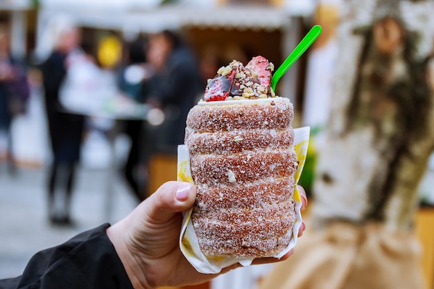 National street food of the Czech Republic. Baking popular trdlo at the street stalls.